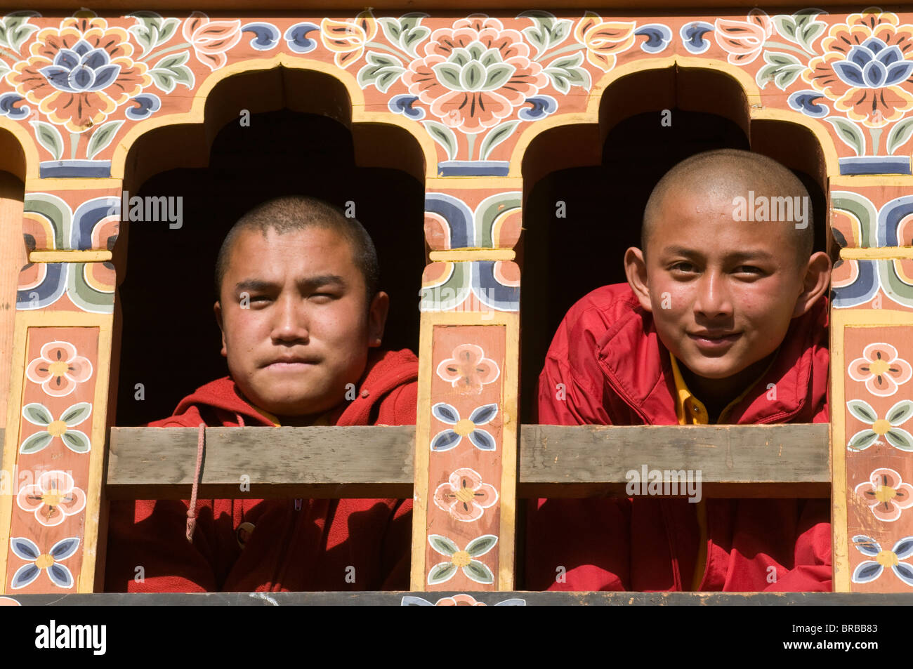 Young Buddhist monks at window, Gangte Goempa, Bhutan Stock Photo