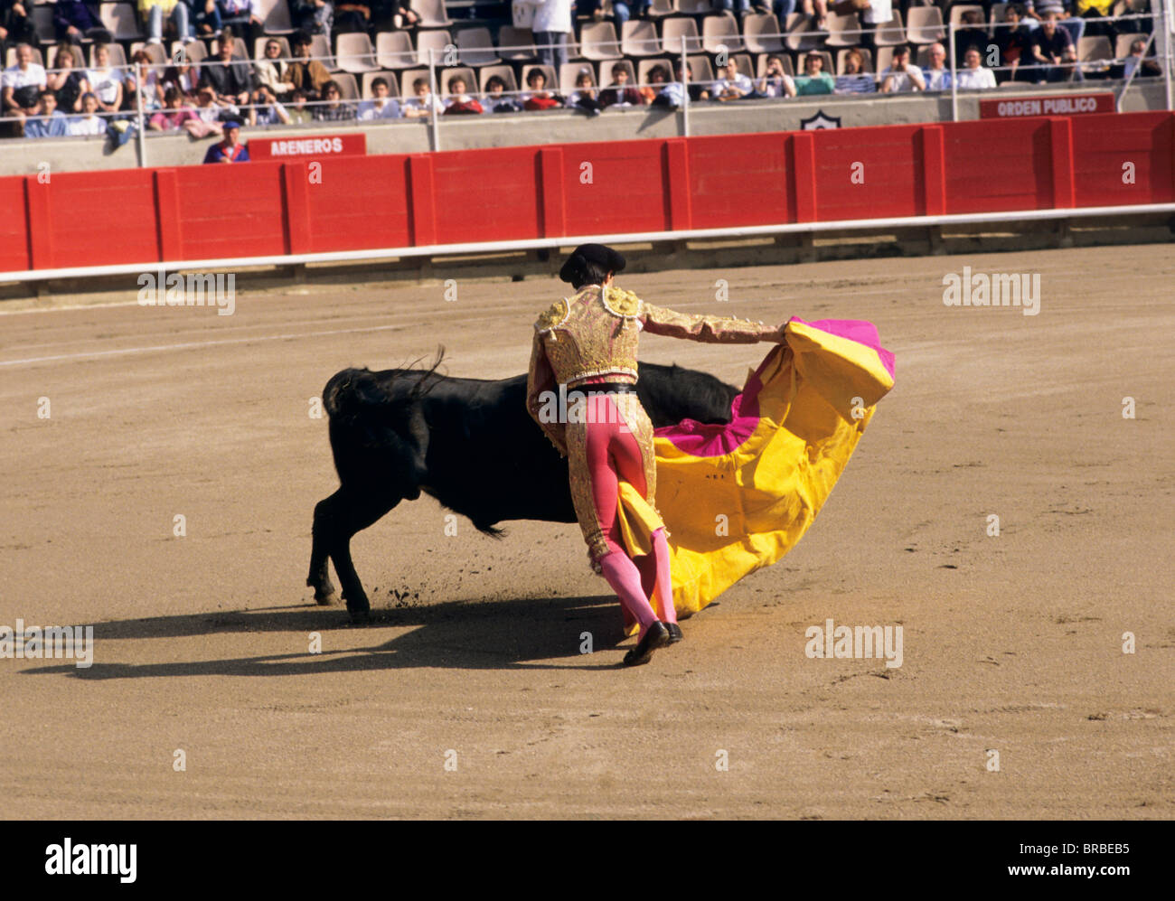 Bullfighter taunting a bull with his cape Stock Photo