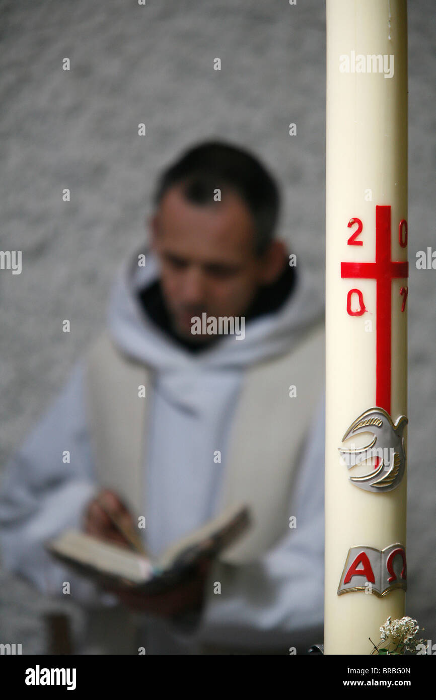 Easter candle and praying monk, Evian, Haute Savoie, France Stock Photo