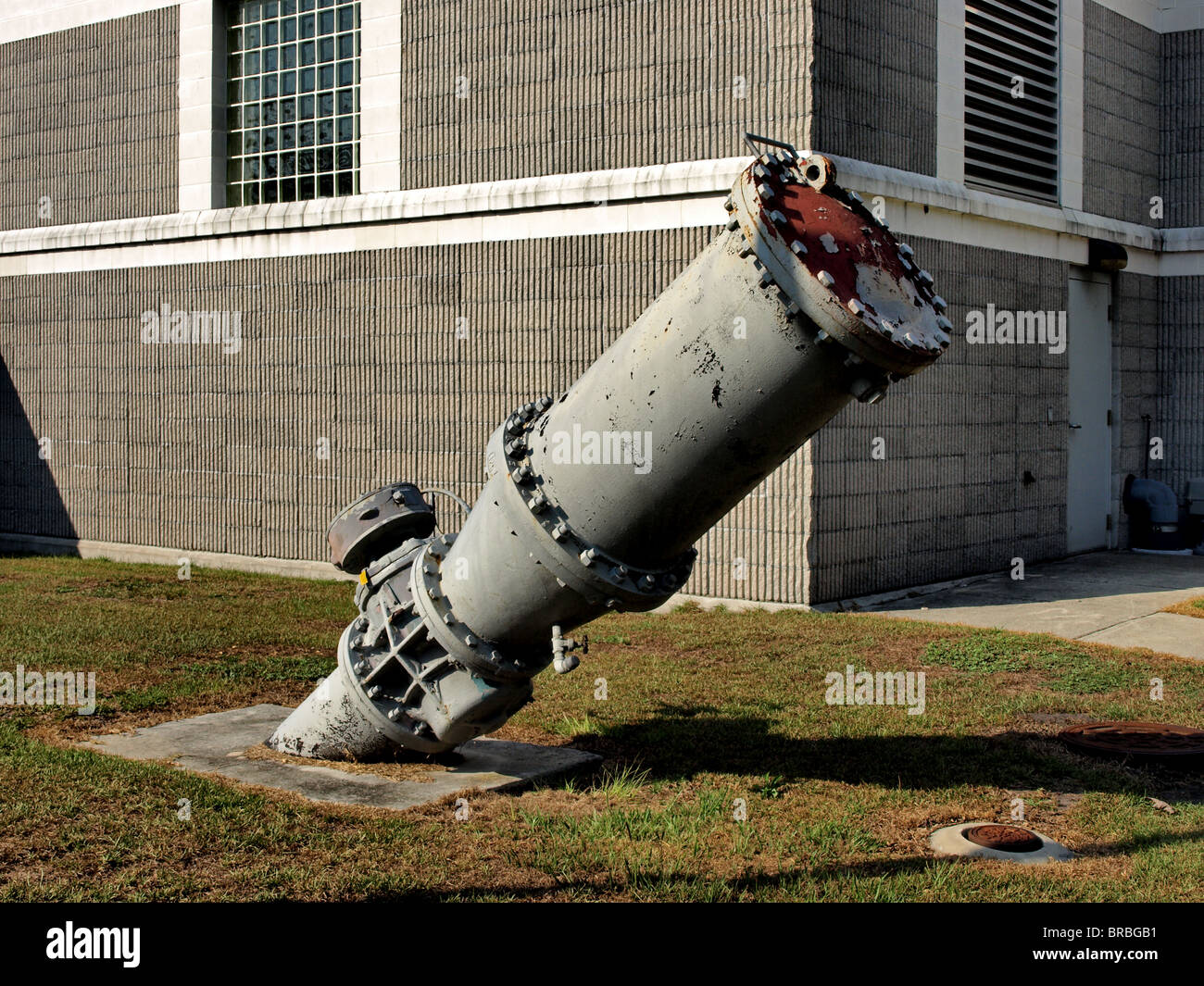 outflow release pipe at waste water treatment lift station made of steel industrial in front of lift station building Stock Photo