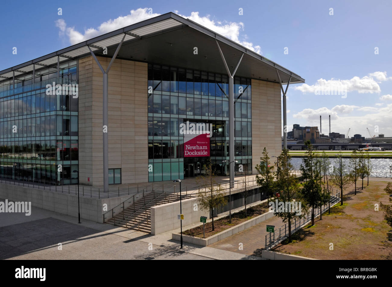 Modern administration offices for Newham council workers beside DLR train station with Royal Docks & London City Airport beyond England UK Stock Photo