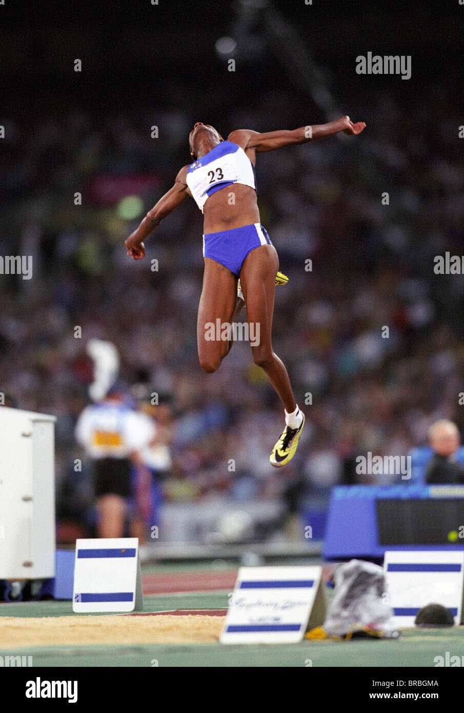 Female long jumper flies through air on jump Stock Photo