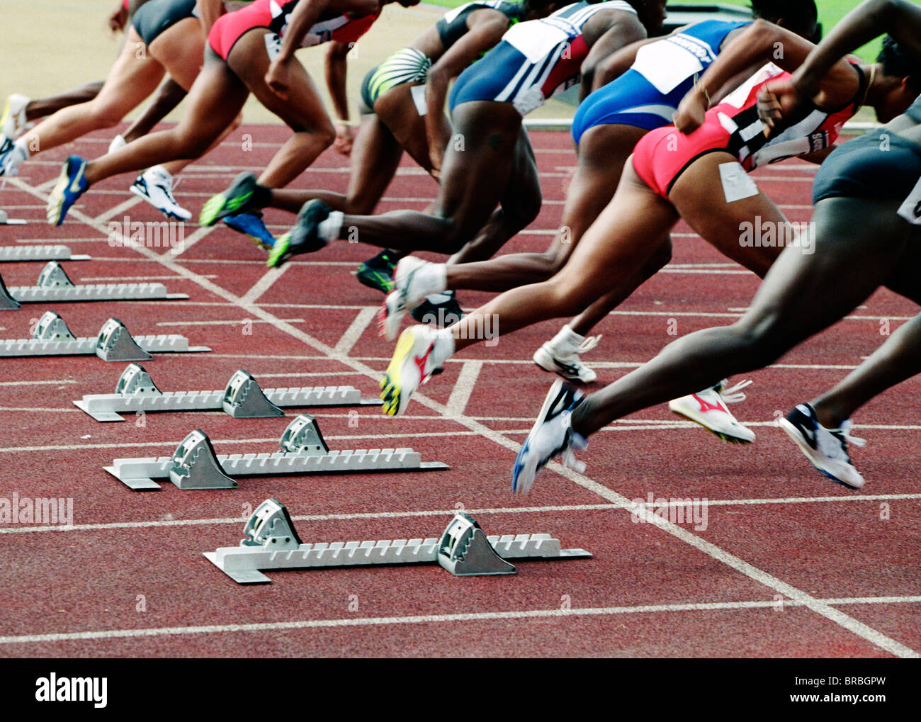 Group of runners leaving the starting blocks Stock Photo Alamy