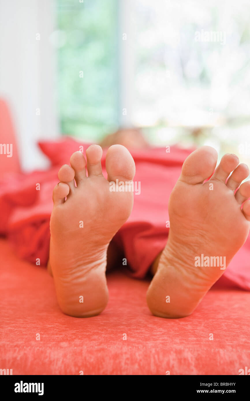 woman sleeping with feet out from covers Stock Photo Alamy