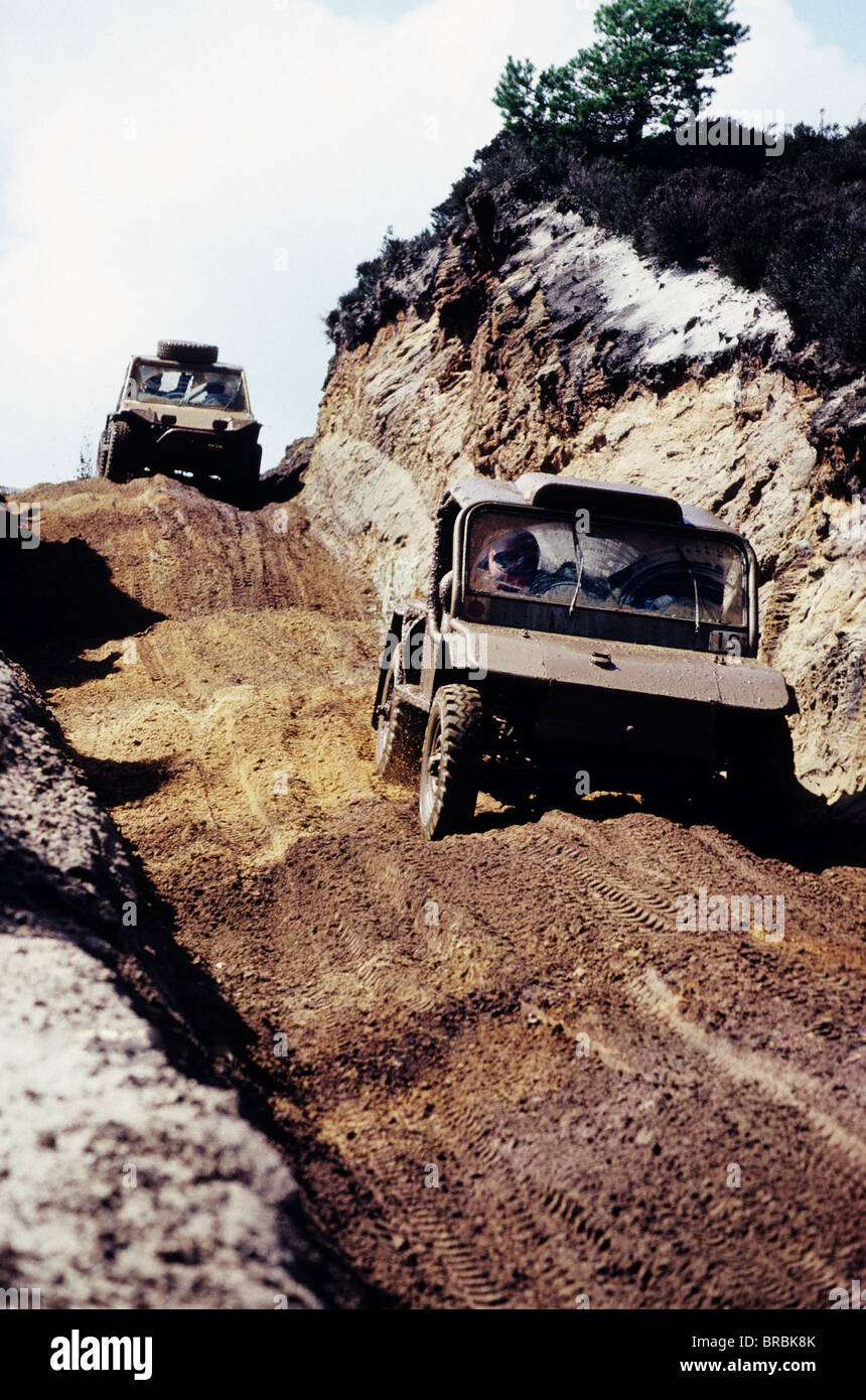 Two off-road all-terraine vehicles travelling down a dirt track Stock Photo