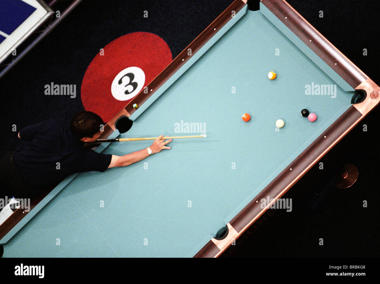 Arial view of a man playing eight ball pool Stock Photo