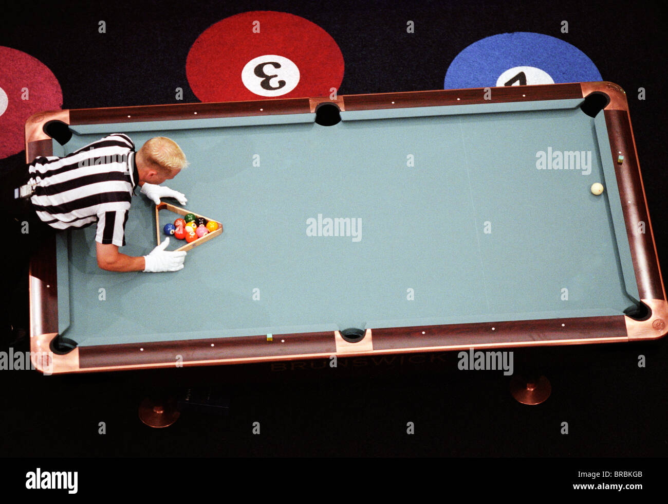 Arial view of official setting up the rack for eight ball pool Stock Photo