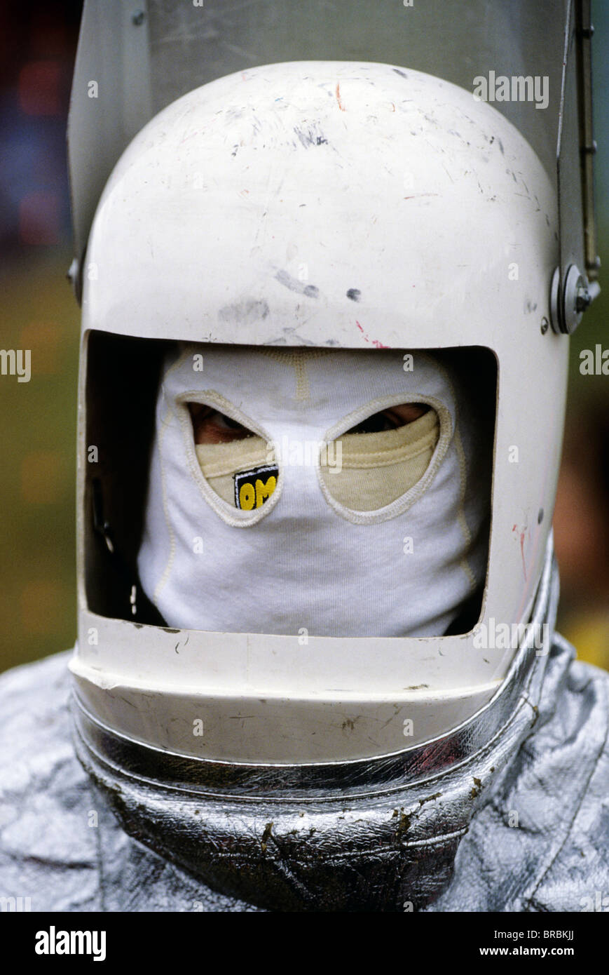 Man wearing a retro helmet and fire proof suit Stock Photo - Alamy