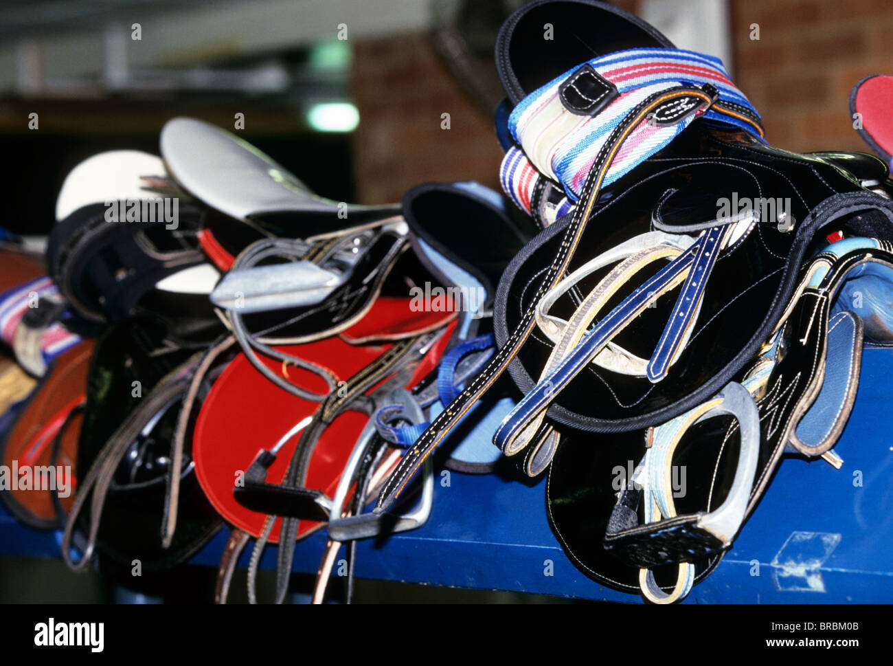 Jockeys saddles waiting to be placed upon the horse at a race track