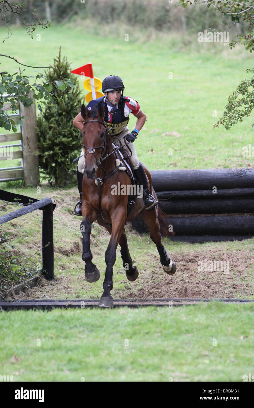 Horse and rider jumping a ditch during the cross country phase of a one