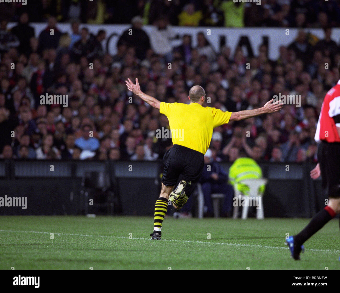 Footballer turns asn celebrates as he scores a goal Stock Photo