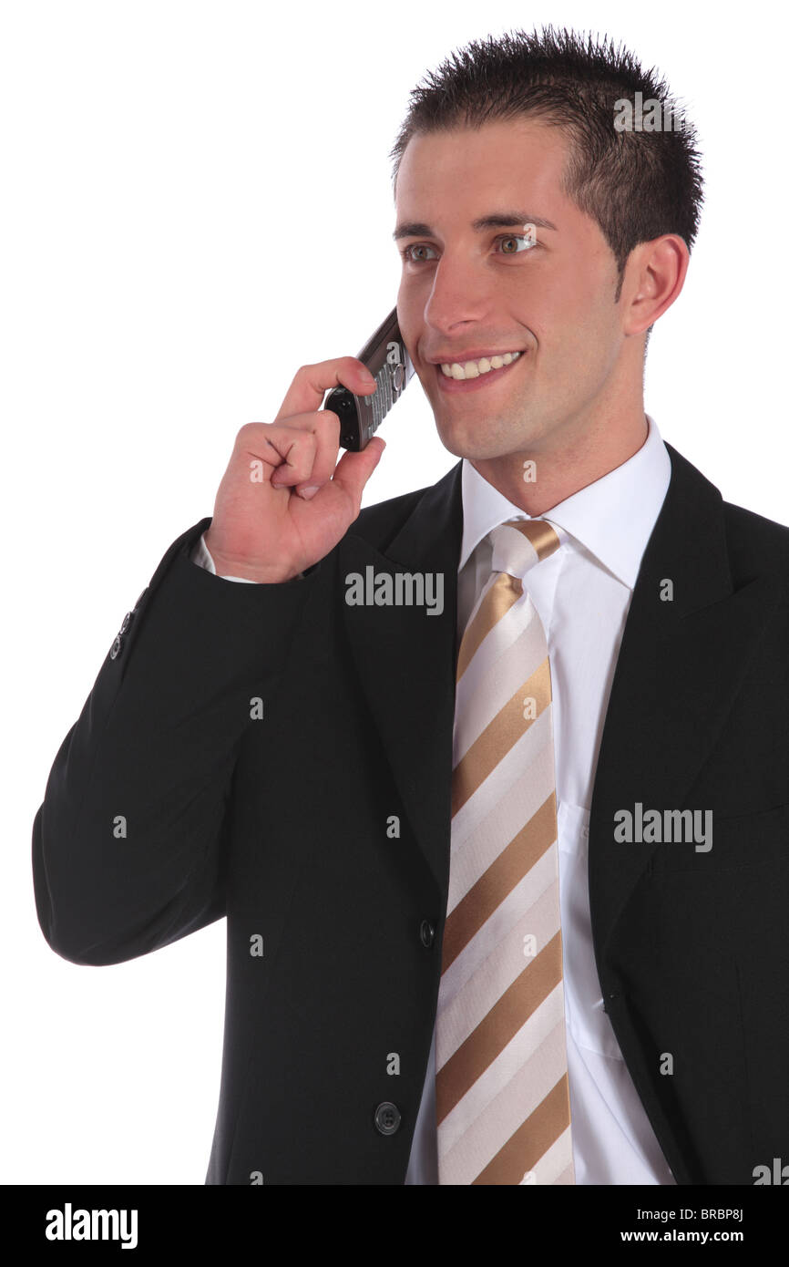 A handsome businessman gets a pleasant call. All on white background. Stock Photo