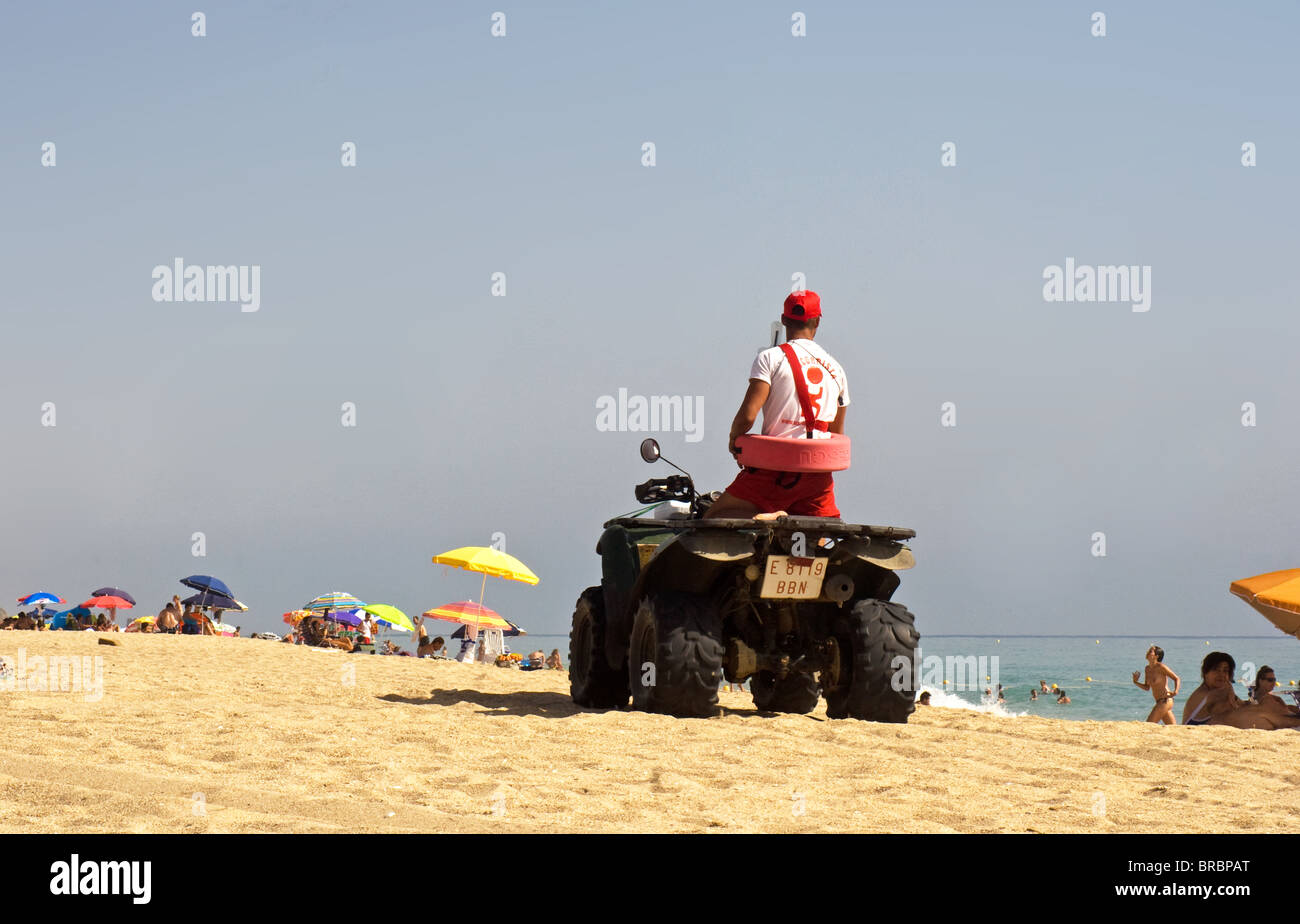 Lifeguard on quad bike on beach at Atlanterra, Zahara de los Atunes Costa de la Luz, Andalucia, Spain Stock Photo