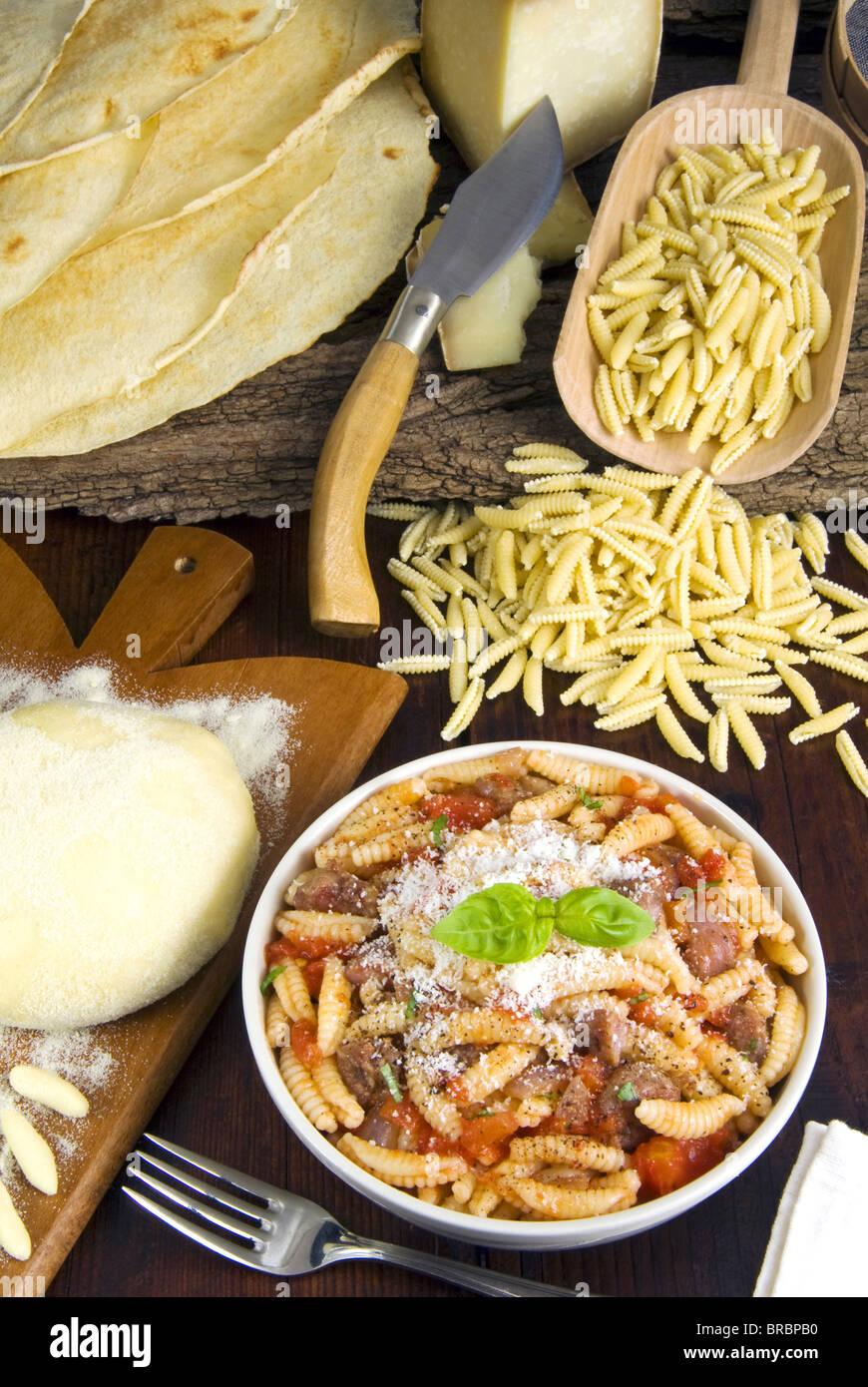 Malloreddus alla Campidanese, Sardinian malloreddus, Carasau bread, Pattada Sardinian knife, Sardinia, Italy Stock Photo