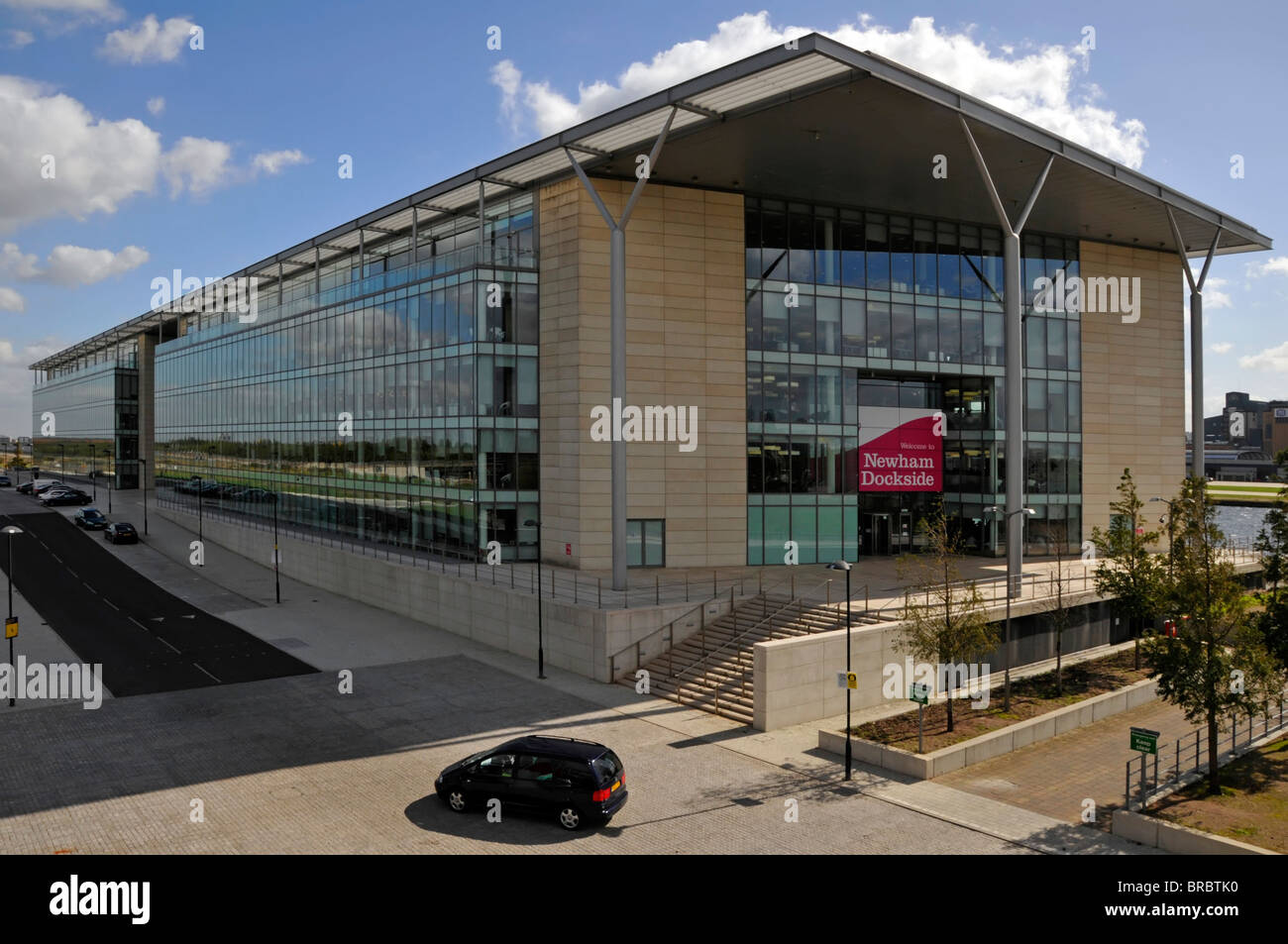Modern administration offices for Newham council workers beside DLR train station with Royal Docks & London City Airport beyond England UK Stock Photo