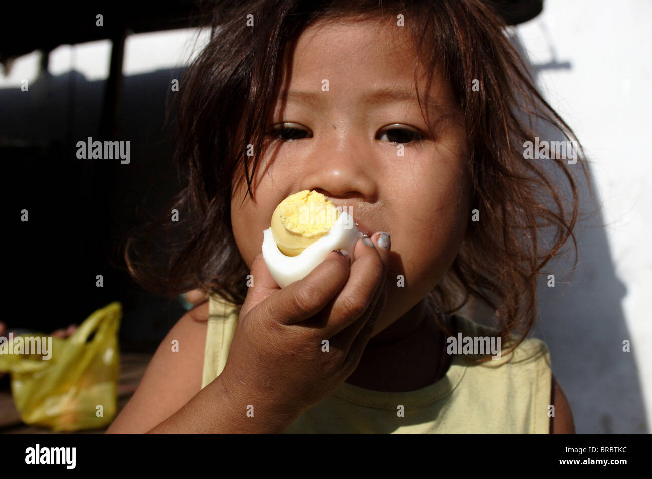 Girl eating boiled egg in breakfast hires stock photography and images