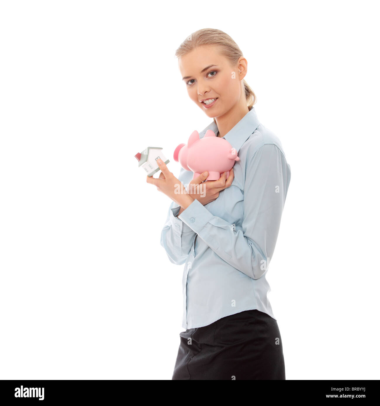 Young beautiful business woman with house model and piggy bank in hands ...