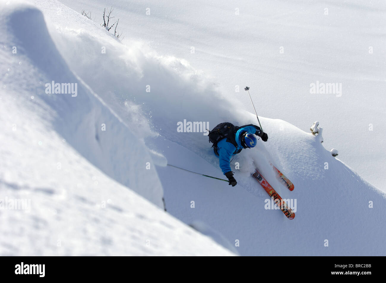 Skier turning fast in deep powder snow Stock Photo