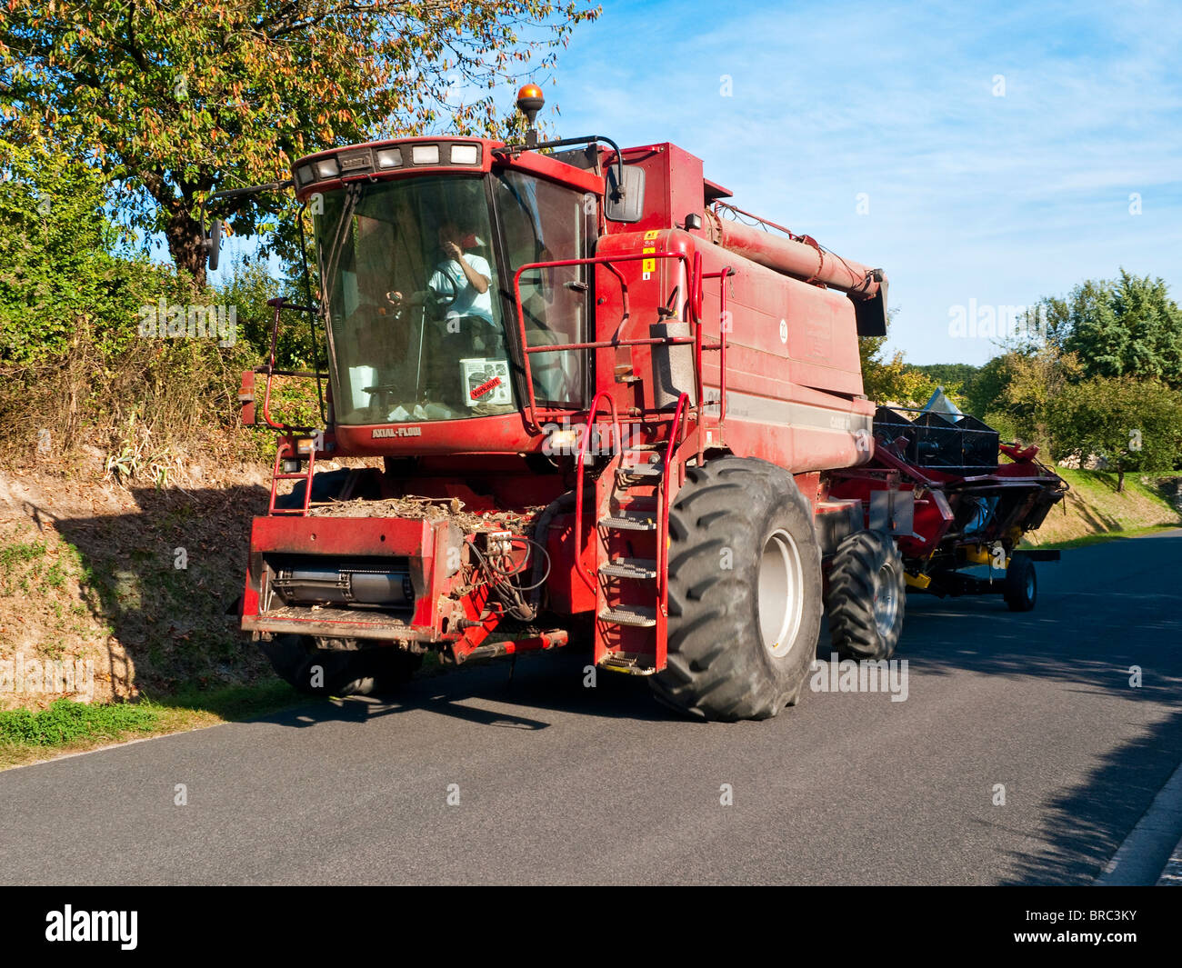 Case III combine harvester towing grain lifter reel on country road