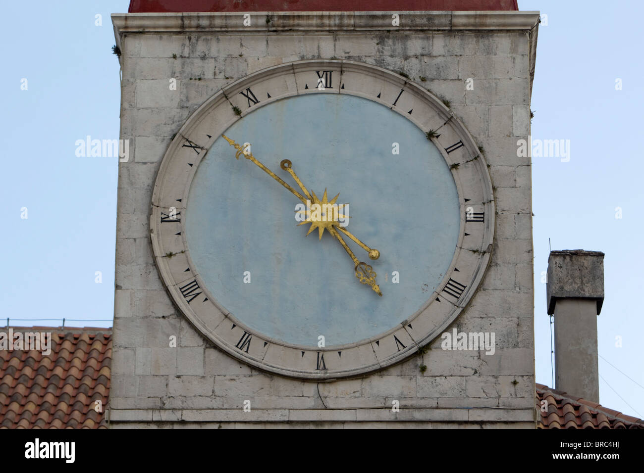 A clock on a building in Trogir, Croatia Stock Photo