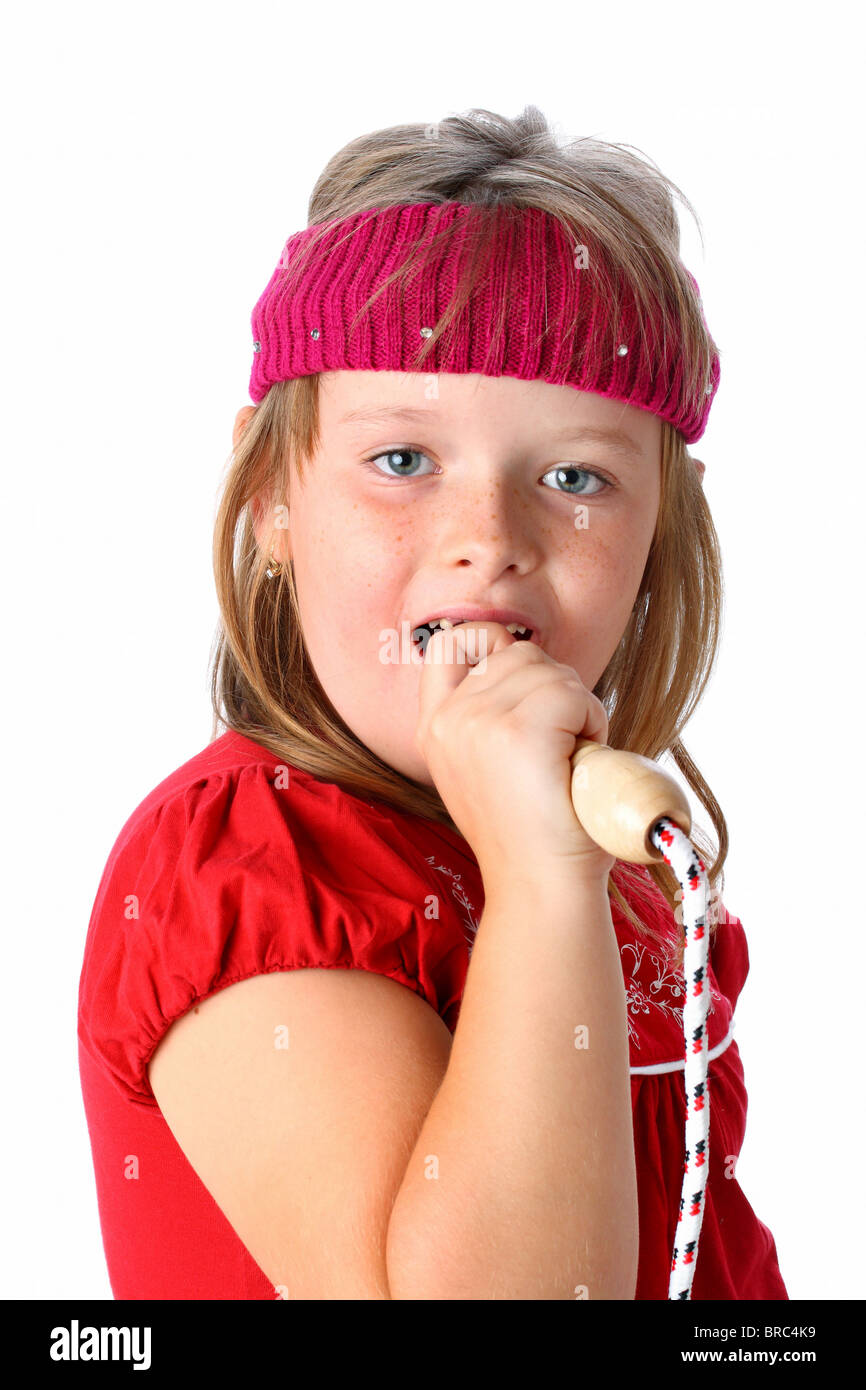 Small Girl Singing A Song Pretending Her Jump Rope To Be A Microphone Isolated On White Stock