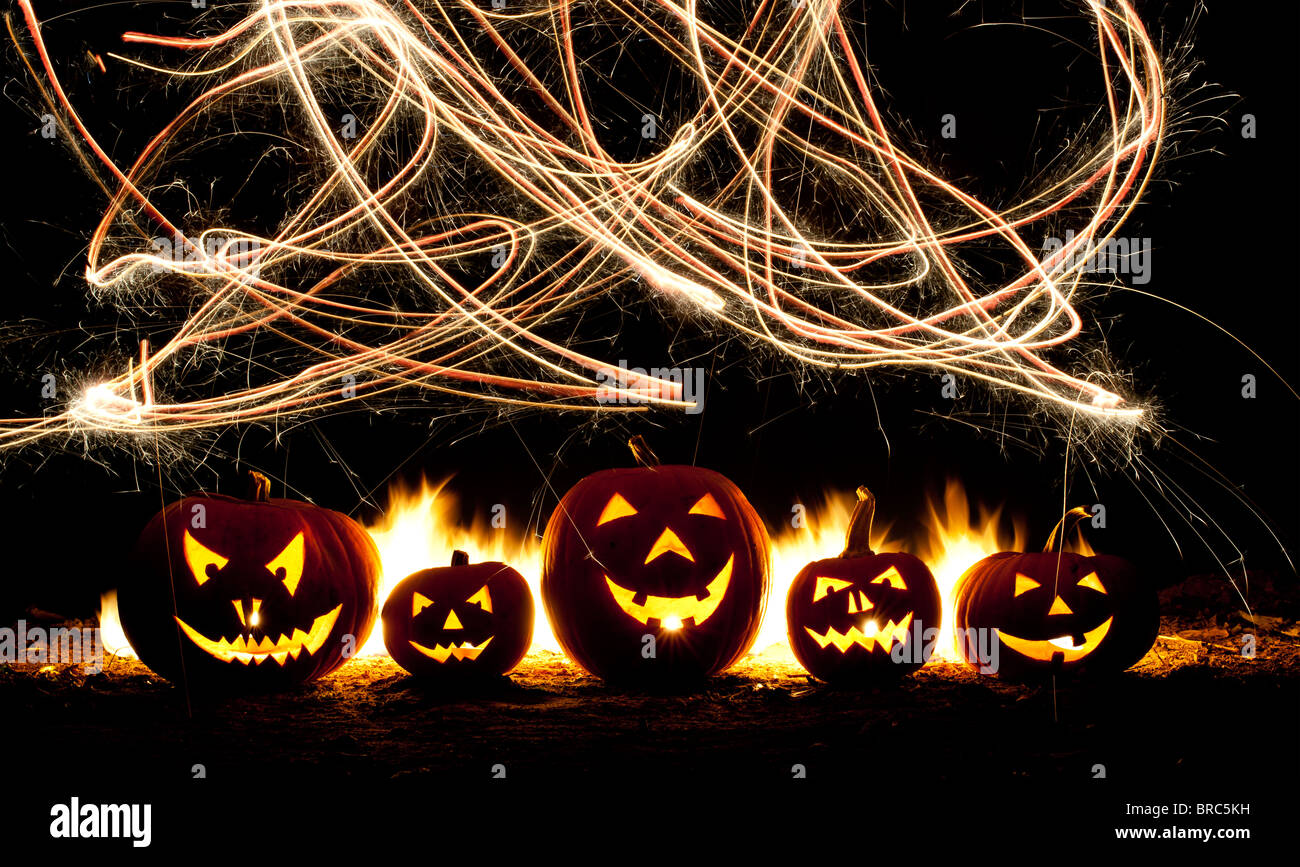 Halloween pumpkins, Jack o lanterns, fire faces and fireworks Stock Photo
