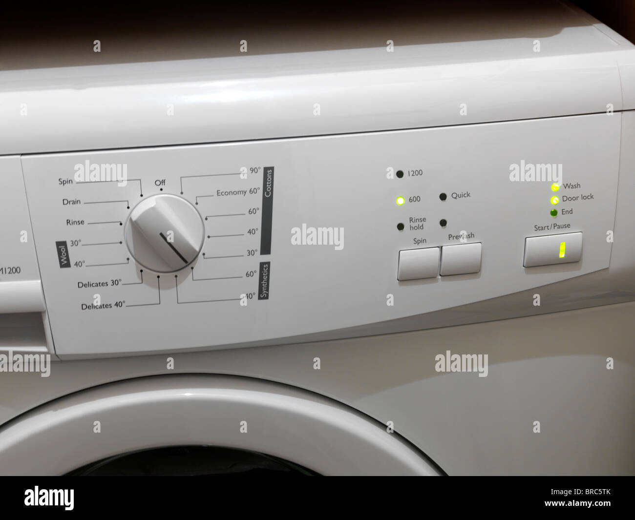 Close Up Of Washing Machine Dial And Start, Pause, Spin And Prewash Buttons Stock Photo