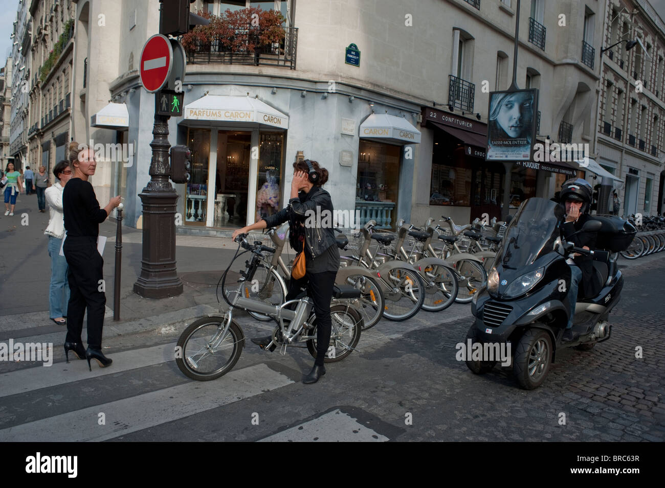 Paris, France,  Busy Parisian Street Scene, People Walking on Avenue Montaigne, Luxury Shopping Street, Woman Bicycling Stock Photo
