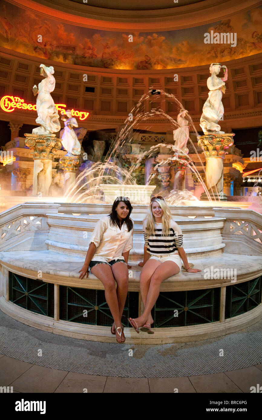 Two teenage girls enjoying the fountains in the Forum shops, Caesars Palace Hotel, Las Vegas USA Stock Photo