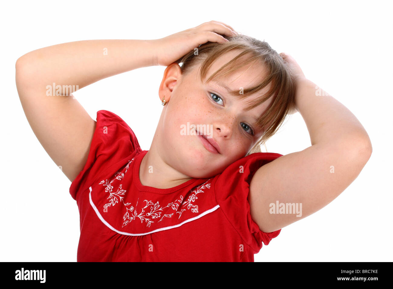 Happy little girl with hands in her hair isolated on white Stock Photo ...