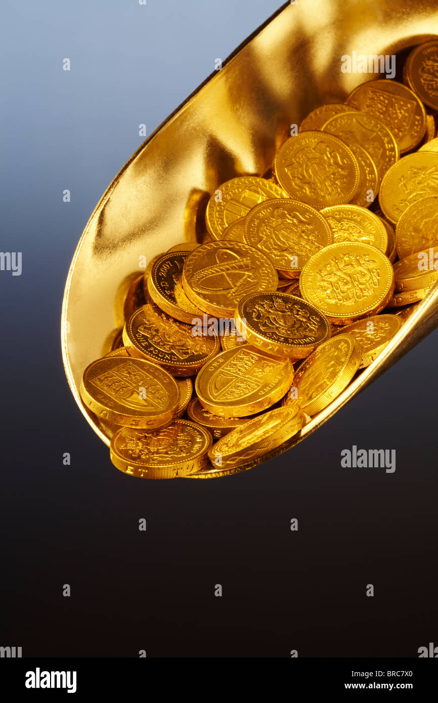 Golden scoop of money, closeup Stock Photo Alamy