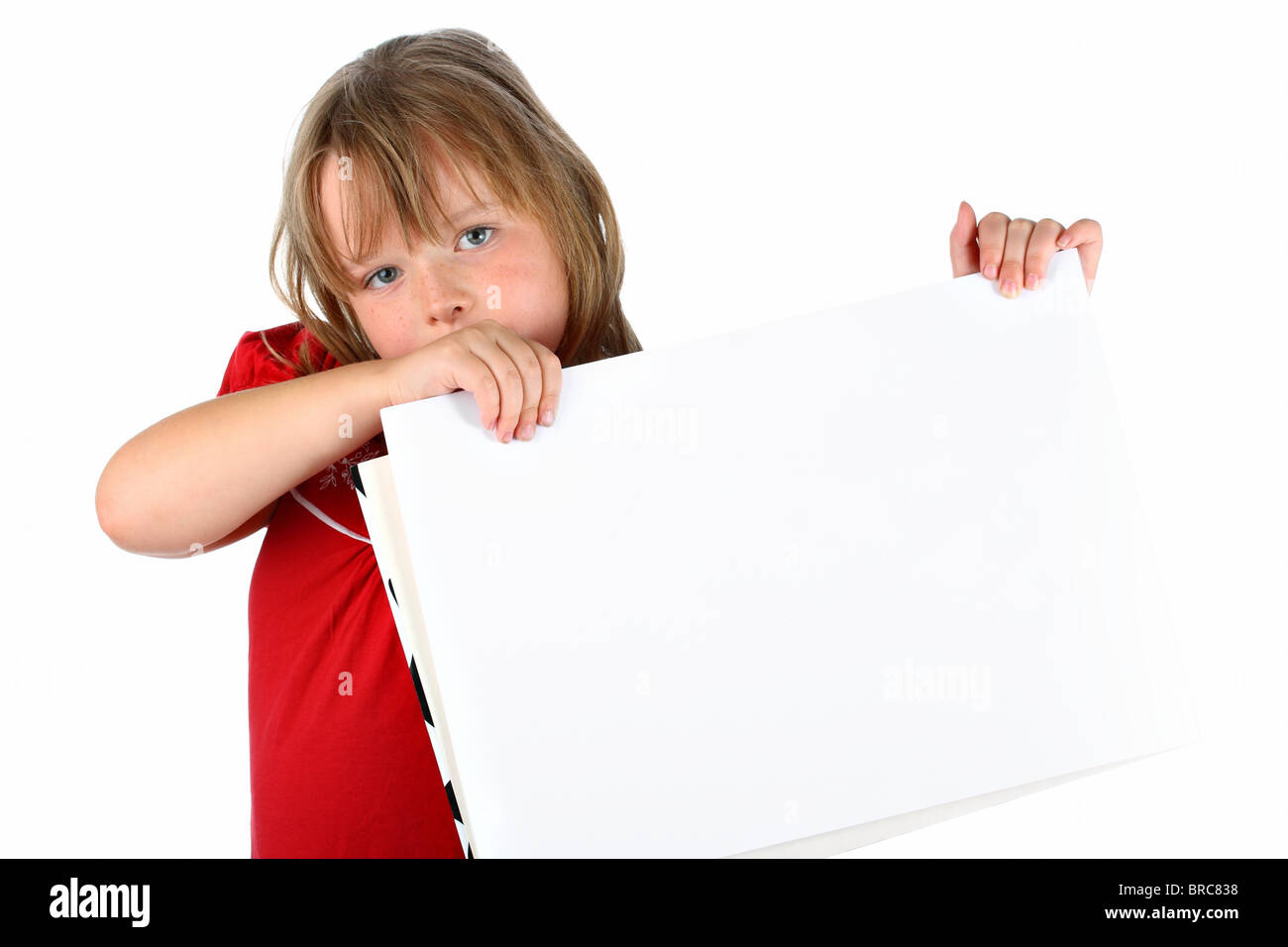 Small girl carrying a blank paper with room for text isolated on white ...