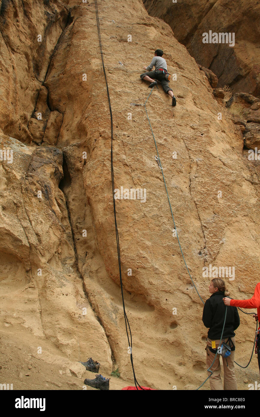 SMITH ROCK STATE PARK, OREGON - MAY 20 -Rock climber works his way up a sheer cliff face on May 20, 2007, in Central Oregon Stock Photo