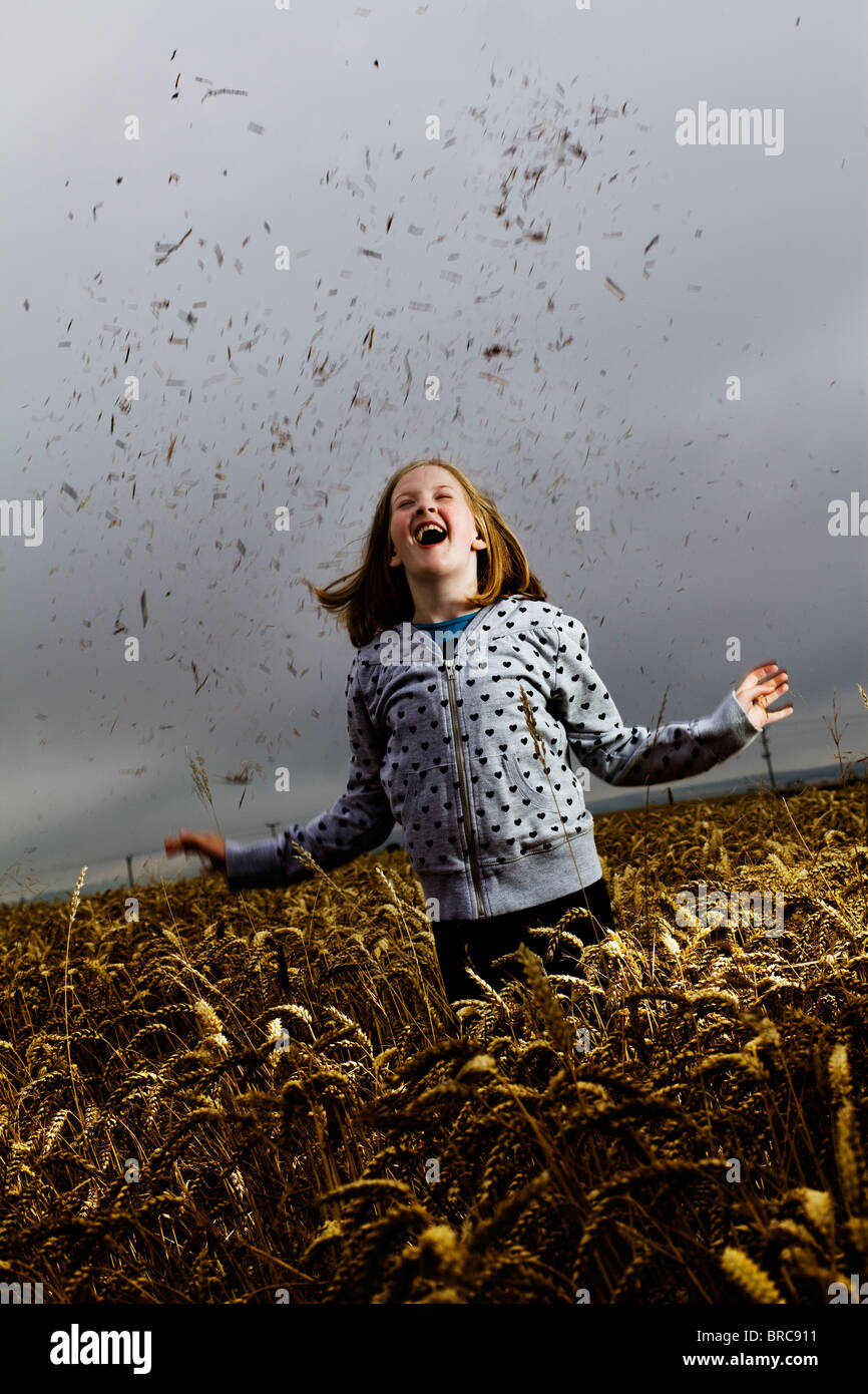 A young girl playing in a wheat field Stock Photo - Alamy