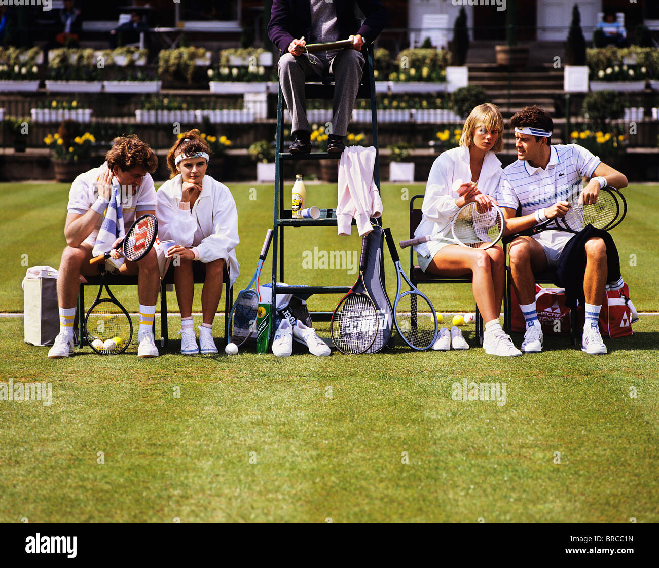 Tennis match at Queens Club ground London, between two couples, mixed