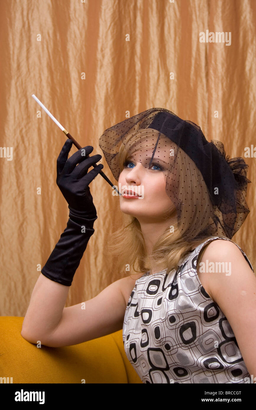 Hamburg, Germany, Woman outfit twenties with cigarette holder Stock Photo -  Alamy