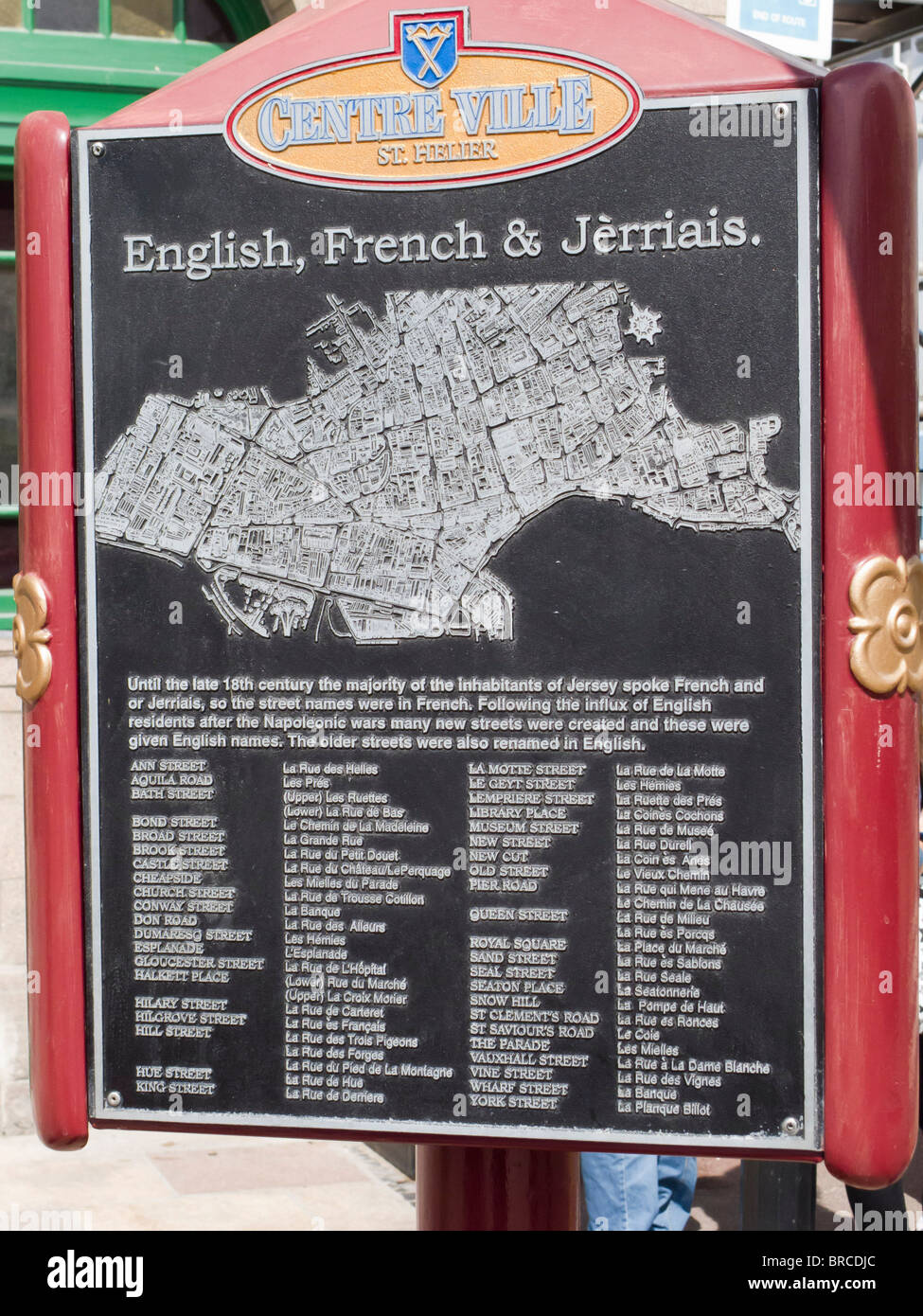 Town sign showing street names in three languages in the centre of St. Helier, Jersey, Channel Islands. Stock Photo