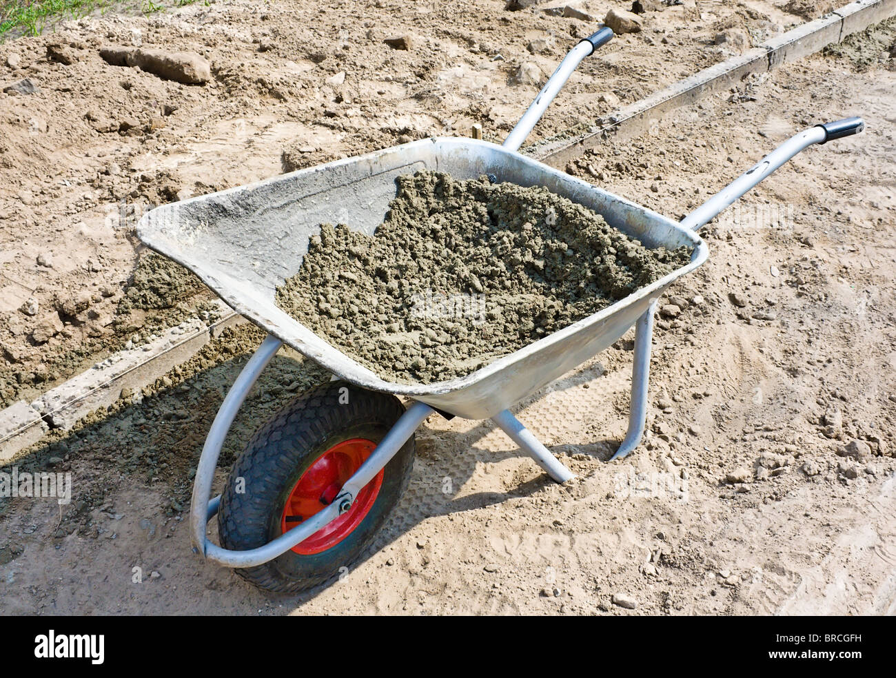 Wheelbarrow with mortar on road construction Stock Photo Alamy