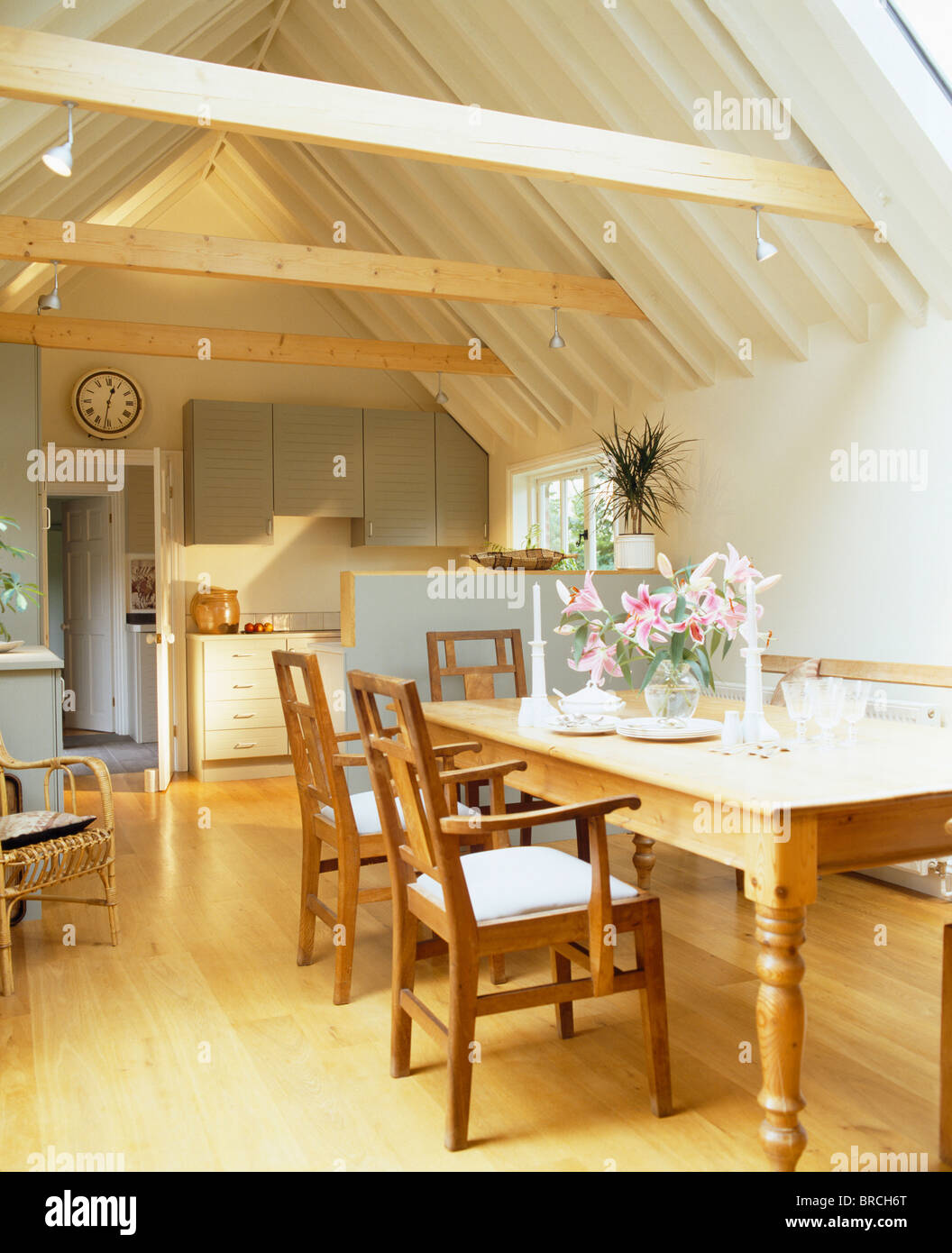 Wooden Chairs And Pine Table In Traditional Kitchen In Small Barn
