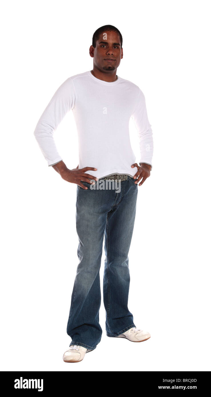 An attractive dark-skinned man standing in front of plain white background. Stock Photo