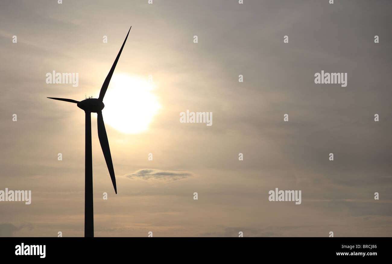 Silhouette of a wind power plant symbolizing sustainable energy supply. Stock Photo