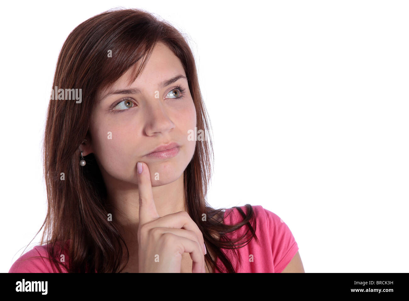 An attractive young woman deliberates a decision. All on white background. Stock Photo