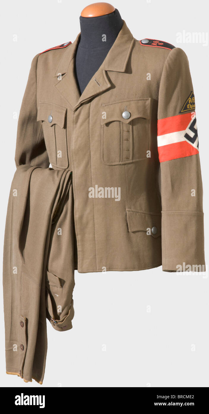 A walking-out uniform for students, of the Adolf Hitler School Chiemsee Tunic of brown gabardine with hidden buttons, golden-yellow silk liner and field grey metal buttons. Sewn-in black shoulder boards with red piping and inscription 'AHS', sleeve triangle 'AHS Chiemsee' and woven armband. Corresponding breeches of the same material (moth damage). historic, historical, 1930s, 1930s, 20th century, League of German Girls, Band of German Maidens, youth organization, youth organizations, NS, National Socialism, Nazism, Third Reich, German Reich, Germany, National , Stock Photo
