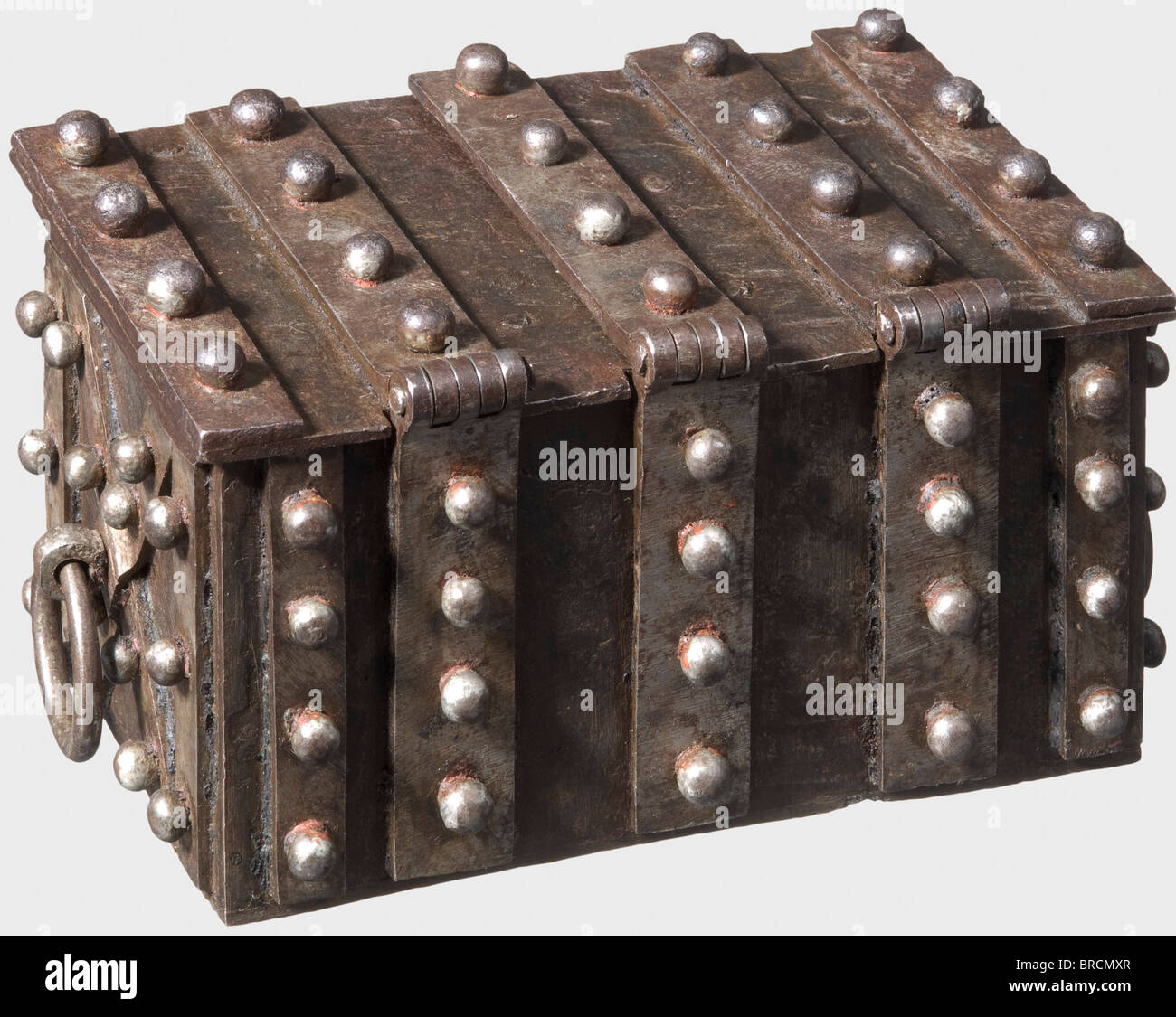 A Nuremberg small strongbox, ca. 1540 Rectangular box made of forged iron sheets. Surrounded by massive reinforcement straps with stud rivets. The hinged lid with three hasps and small triangular locks. On both sides moveable handle rings. Elaborate lock mechanism with two secret locks. On the front a concealed key hole with secret release device. The inside with intricately worked locking mechanism, which reveals the central strap of the lid. On the front a second secret mechanism: when a rivet is turned, a double latch is moved. The lid with elaborate locking, Stock Photo