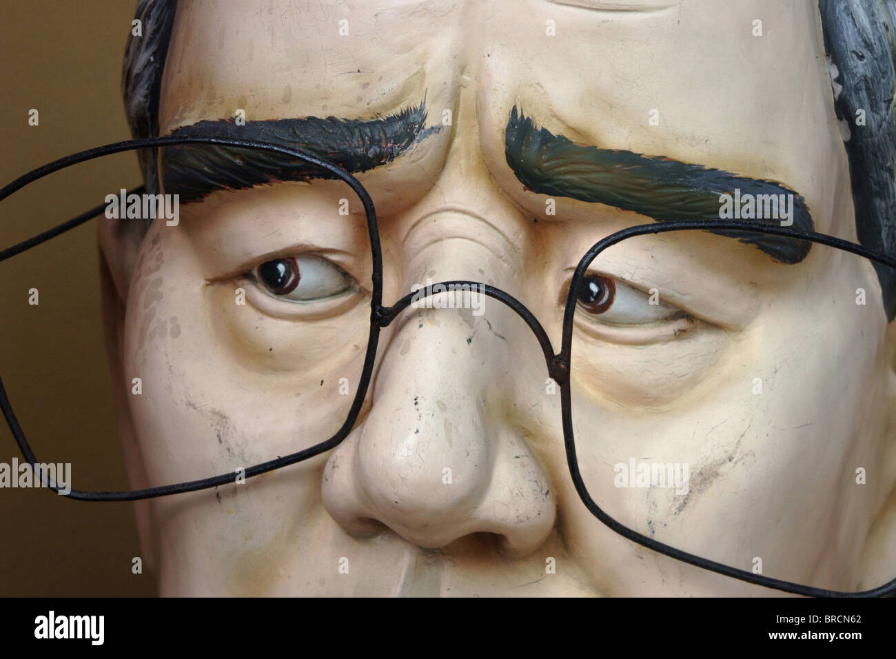 An unusual plastic sculpture depicting an Asian man is part of the urban landscape at the Red Rose Hotel in Chiang Rai, Thailand Stock Photo