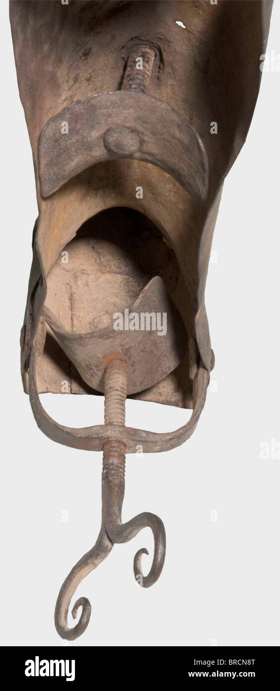 A German leg breaker, 17th/18th century Cuisse and greave connected by a plain poleyn and thus kept flexible. The sabaton with three riveted segments. In the shin and heel area two hand screws mounted in opposite direction. The cuisse was fixed to the deliquent's thigh by a back hinge. The surfaces with small rust holes in the knee and sole section. Length 77 cm. By turning the screws, the calves of the delinquent could be painfully crushed, resp. the shinbone, calfbone and various foot bones could be broken. historic, historical, 18th century, 17th century, in, Stock Photo