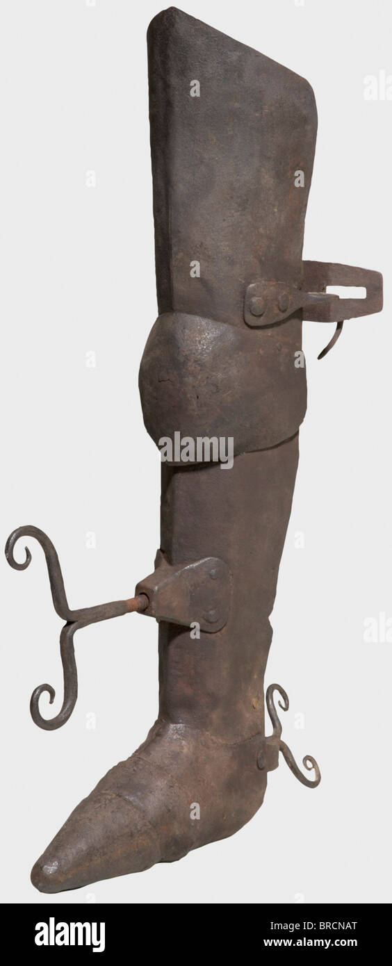A German leg breaker, 17th/18th century Cuisse and greave connected by a plain poleyn and thus kept flexible. The sabaton with three riveted segments. In the shin and heel area two hand screws mounted in opposite direction. The cuisse was fixed to the deliquent's thigh by a back hinge. The surfaces with small rust holes in the knee and sole section. Length 77 cm. By turning the screws, the calves of the delinquent could be painfully crushed, resp. the shinbone, calfbone and various foot bones could be broken. historic, historical,, 18th century, 17th century, i, Stock Photo