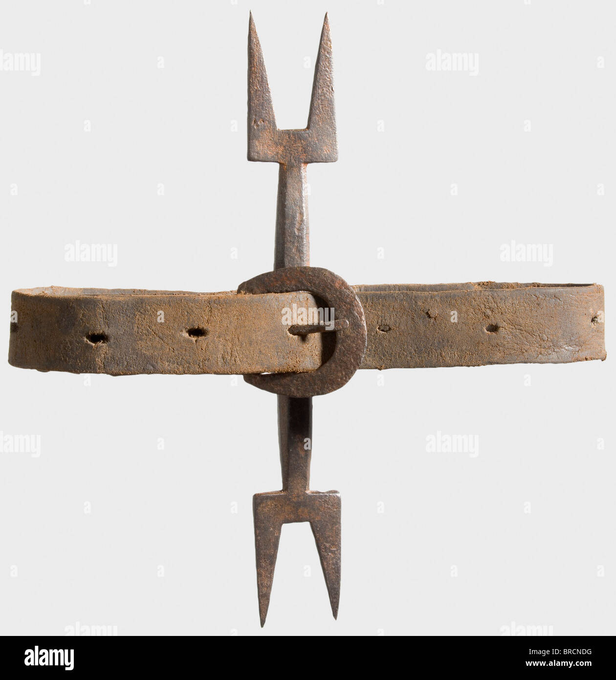 A heretic's fork, Spain or Spanish Netherlands, 17th century Iron shaft with a two-pronged fork on both ends. In the centre two loops with an an iron buckled leather collar. Metal surfaces rusty and partially pitted, with signs of age. Length of the fork 23 cm. The prongs of the fork pierced the skin under the chin and over the breastbone, causing pain and preventing a natural position of the head. A heretic was thus supposedly forced to look his judge in the eye. It is, however, more likely that this torture device was used to thoroughly demoralise the victim., Stock Photo