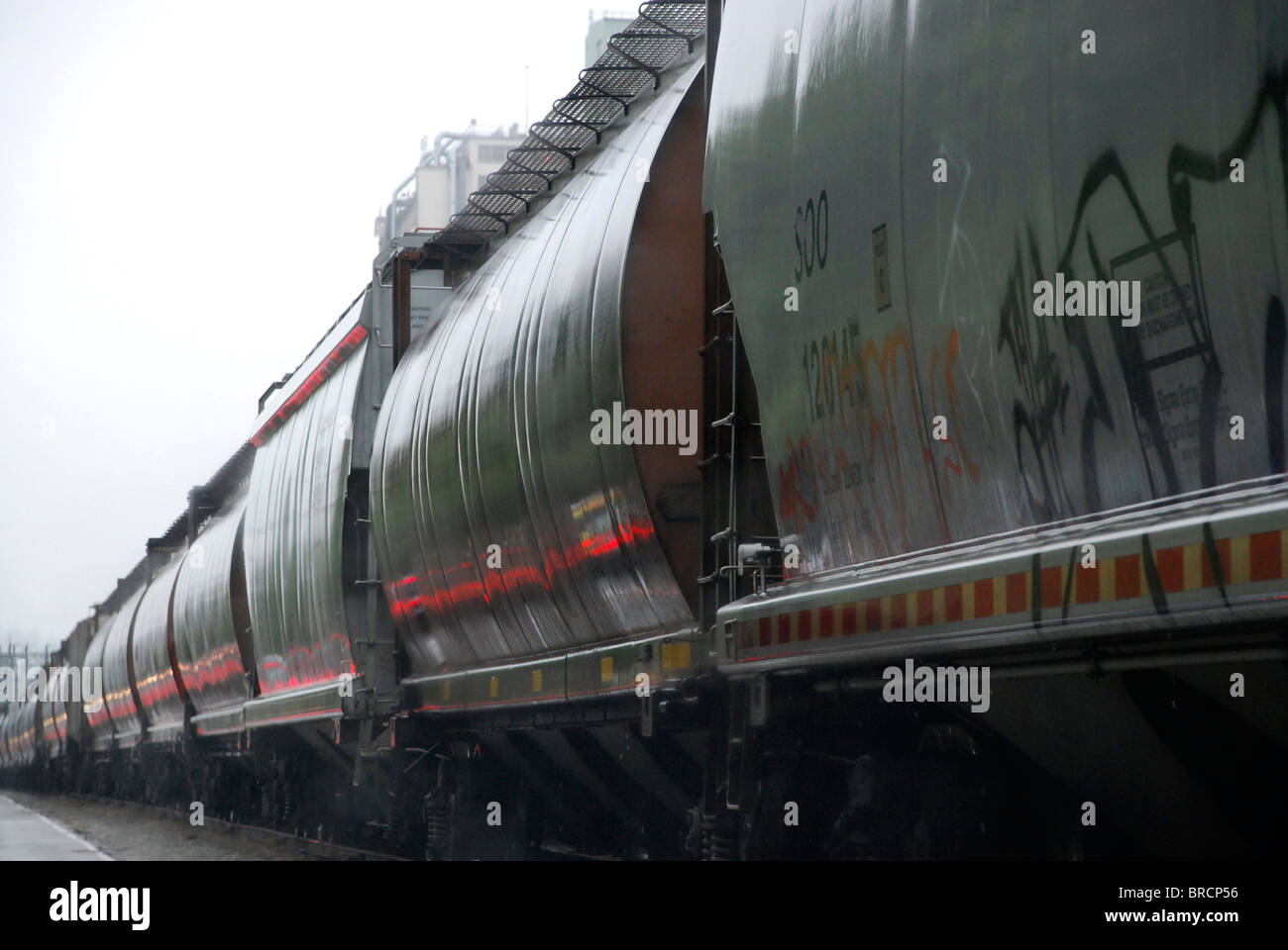 Freight cars in rain in rail yard in North Vancouver BC British Columbia Canada Stock Photo