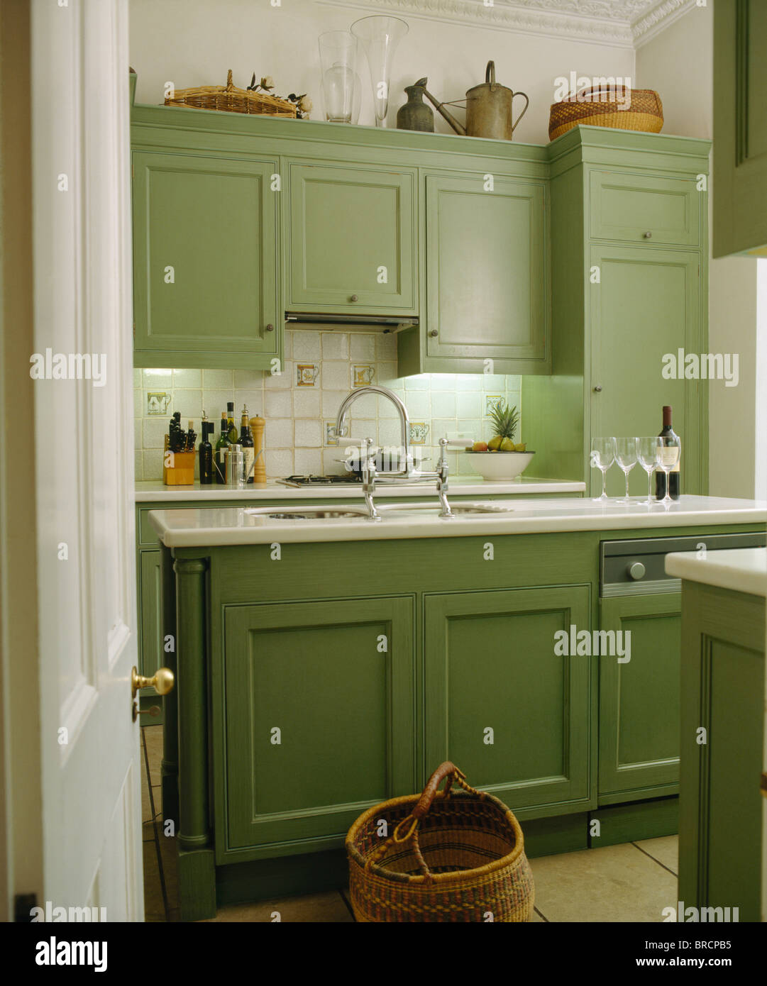 Pale green fitted cupboards and units in traditional kitchen Stock Photo - Alamy